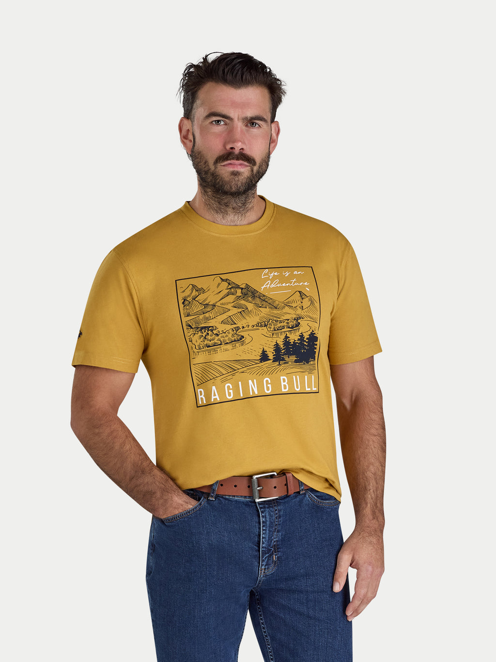 Man wearing a yellow t-shirt with a graphic design and text, standing against a plain background