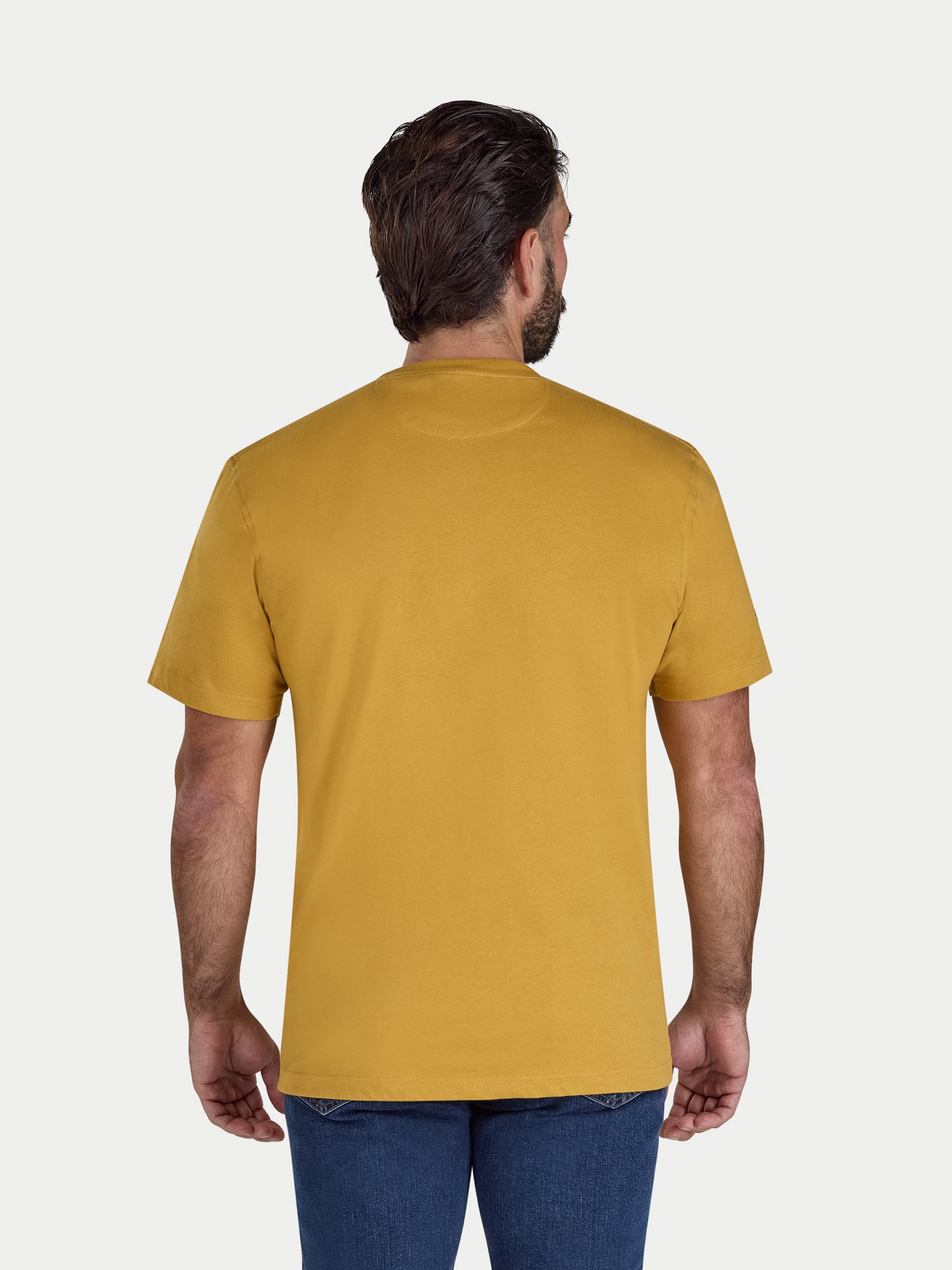 Man wearing a mustard yellow t-shirt on a white background