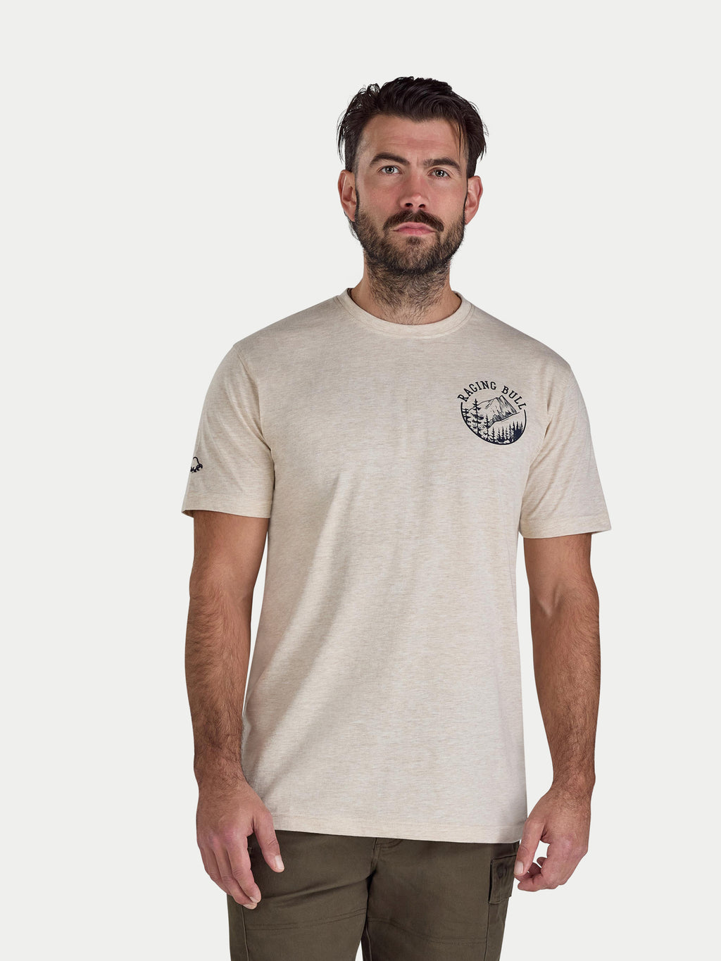 Man wearing a beige t-shirt with a logo on a white background