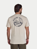 Man wearing a beige t-shirt with 'Raging Bull' logo on the back, standing against a white background