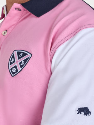 Close-up of a pink and white polo shirt with a logo on a white background