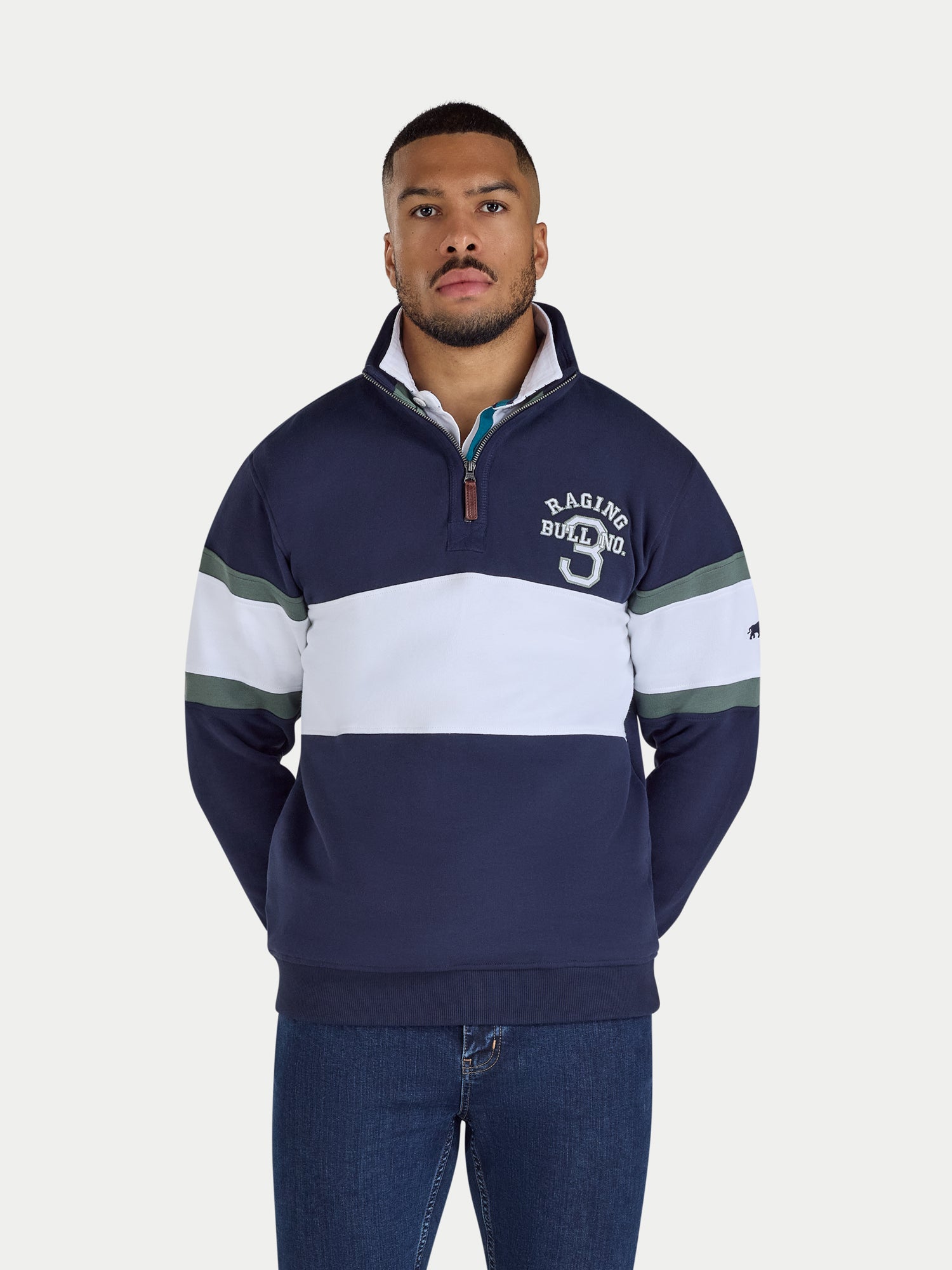 Man wearing a navy and white striped sweater with a logo on a white background