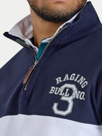 Navy and white jacket with 'Raging Bull' branding on a light gray background