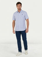 Man wearing Raging Bull Orleans Seersucker Stripe Short Sleeve Shirt in Navy and Regular Fit Jeans in Denim, available in sizes S-6XL.