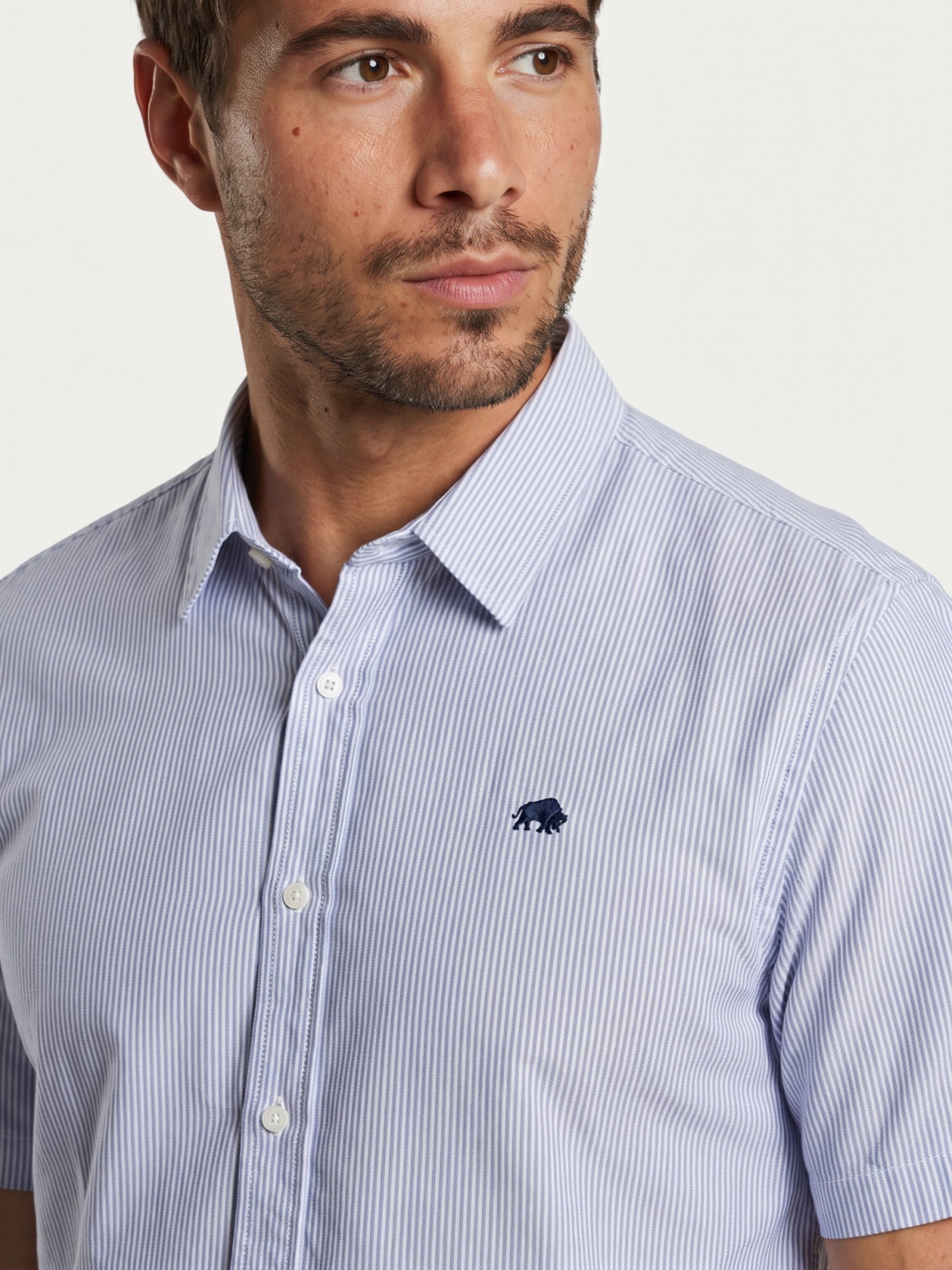 Close-up of a man wearing Raging Bull Orleans Seersucker Stripe Short Sleeve Shirt in Navy, available in sizes S-6XL, front.