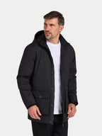 Man wearing a black jacket over a white shirt on a white background