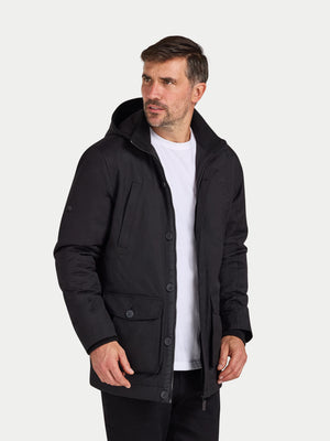 Man wearing a black jacket over a white shirt on a white background