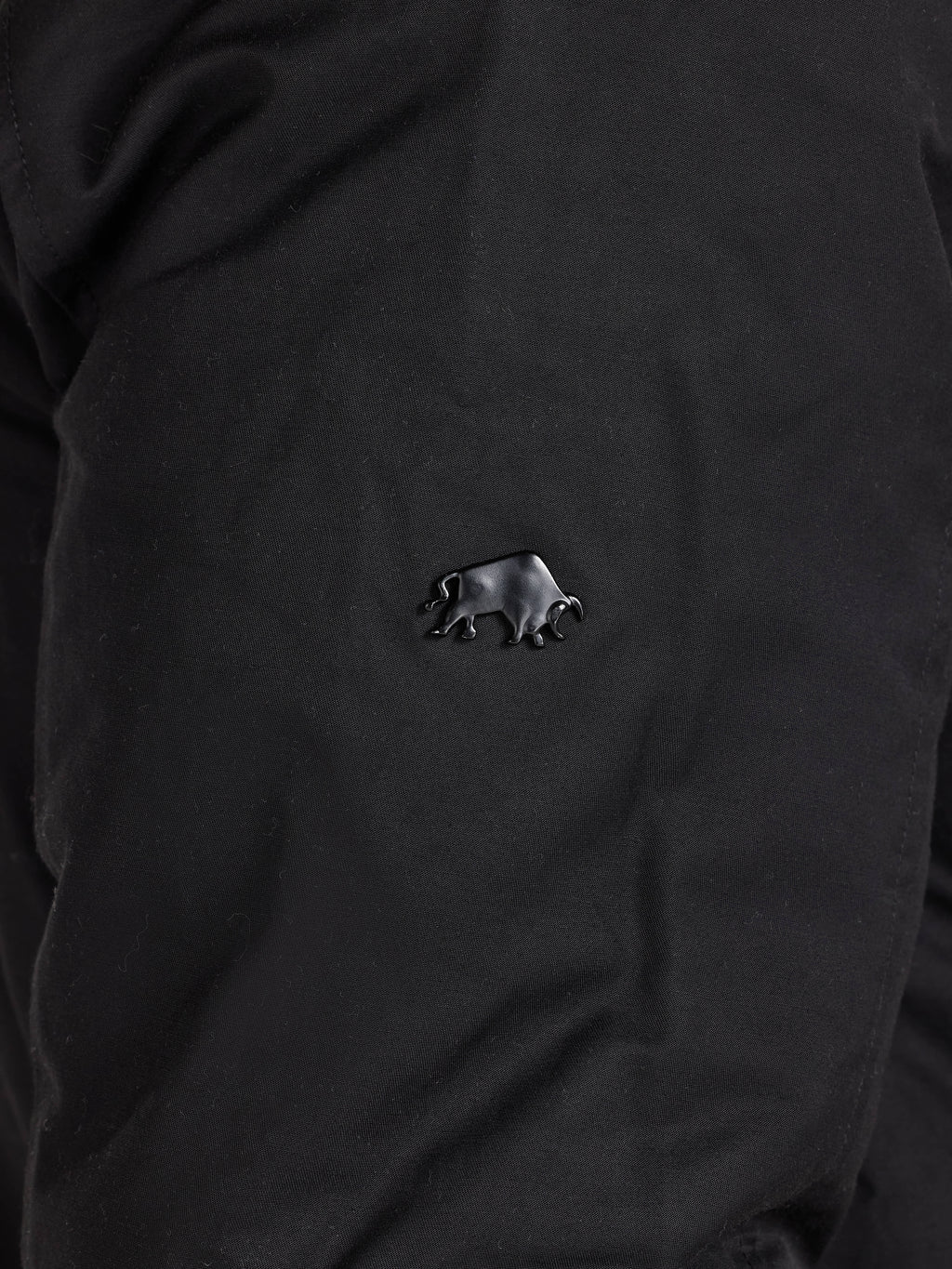 Black shirt with a small bear emblem on the chest.