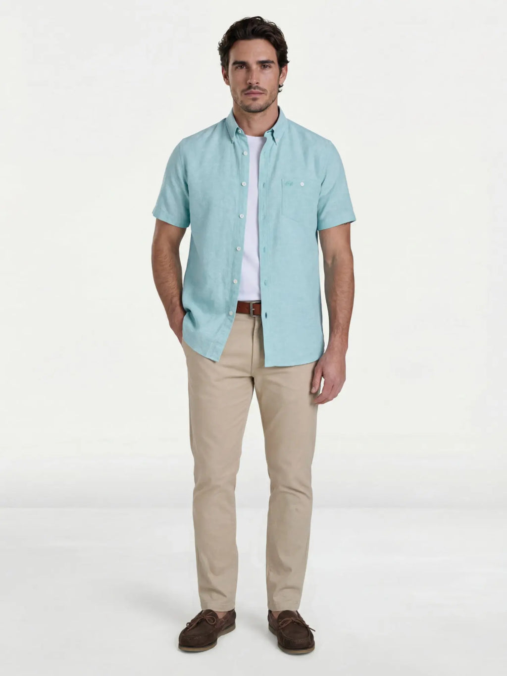 Man wearing Raging Bull Classic Linen Short Sleeve Shirt in Apple Green, Organic T-Shirt in white and Classic Chino Trousers in tan, available in sizes S-6XL.