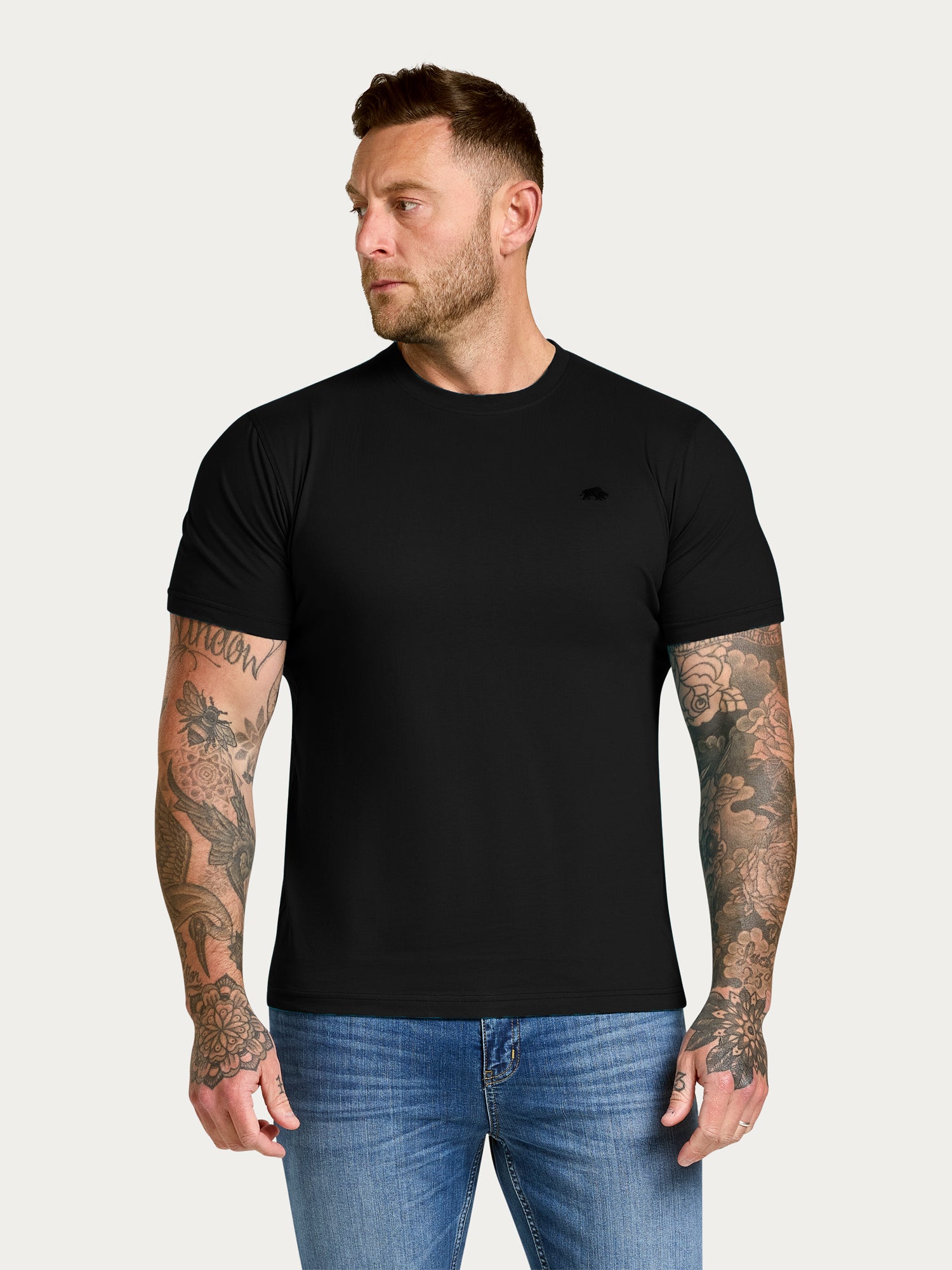 Man wearing Raging Bull Classic Organic t-shirt in black, front.