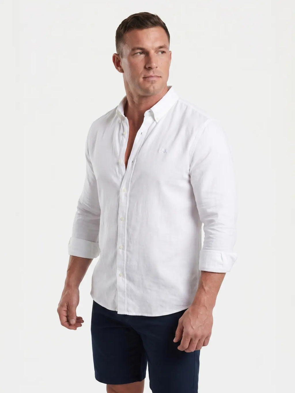 Man wearing Raging Bull linen shirt in white, side. 