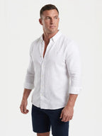 Man wearing Raging Bull linen shirt in white, side. 