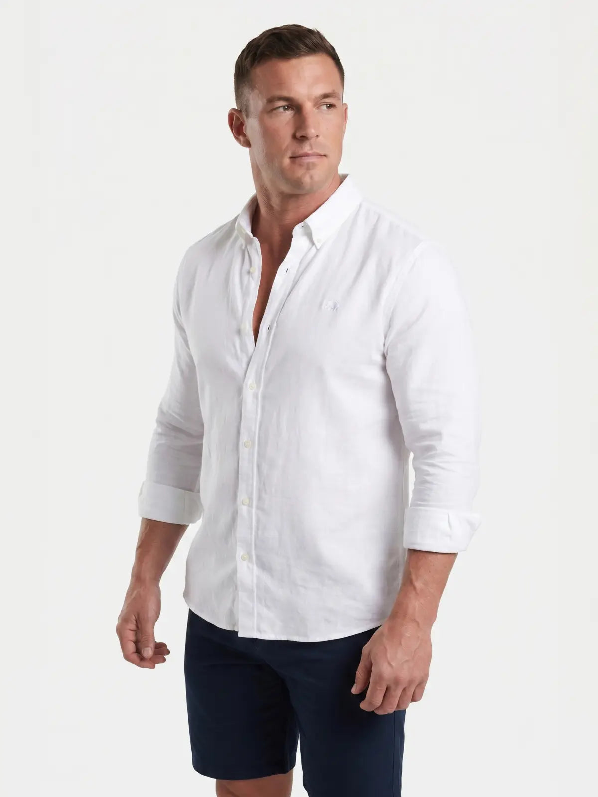 Man wearing Raging Bull linen shirt in white, side. 