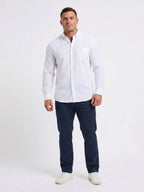 Man wearing Raging Bull Linen Look Long Sleeve Shirt in White and Classic Chino Shorts in Navy, available in sizes S-6XL, front.