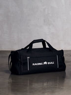 Black raging bull bag on the floor with a grey backround