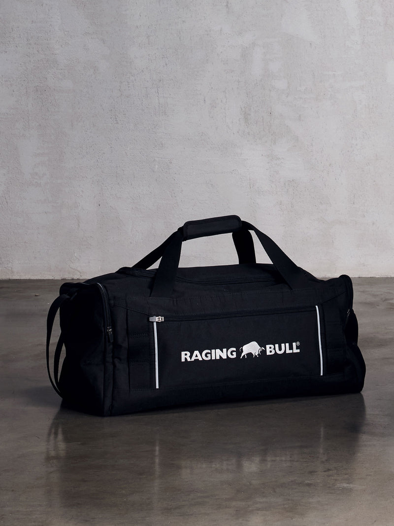 Black raging bull bag on the floor with a grey backround