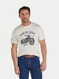 Man wearing a cream t-shirt with a motorcycle graphic and text on a white background