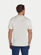 Man wearing a plain white t-shirt and blue jeans on a light gray background