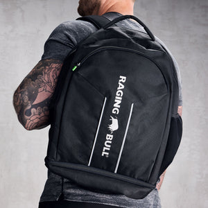 Close-up of a black rucksack with a Raging Bull logo. 