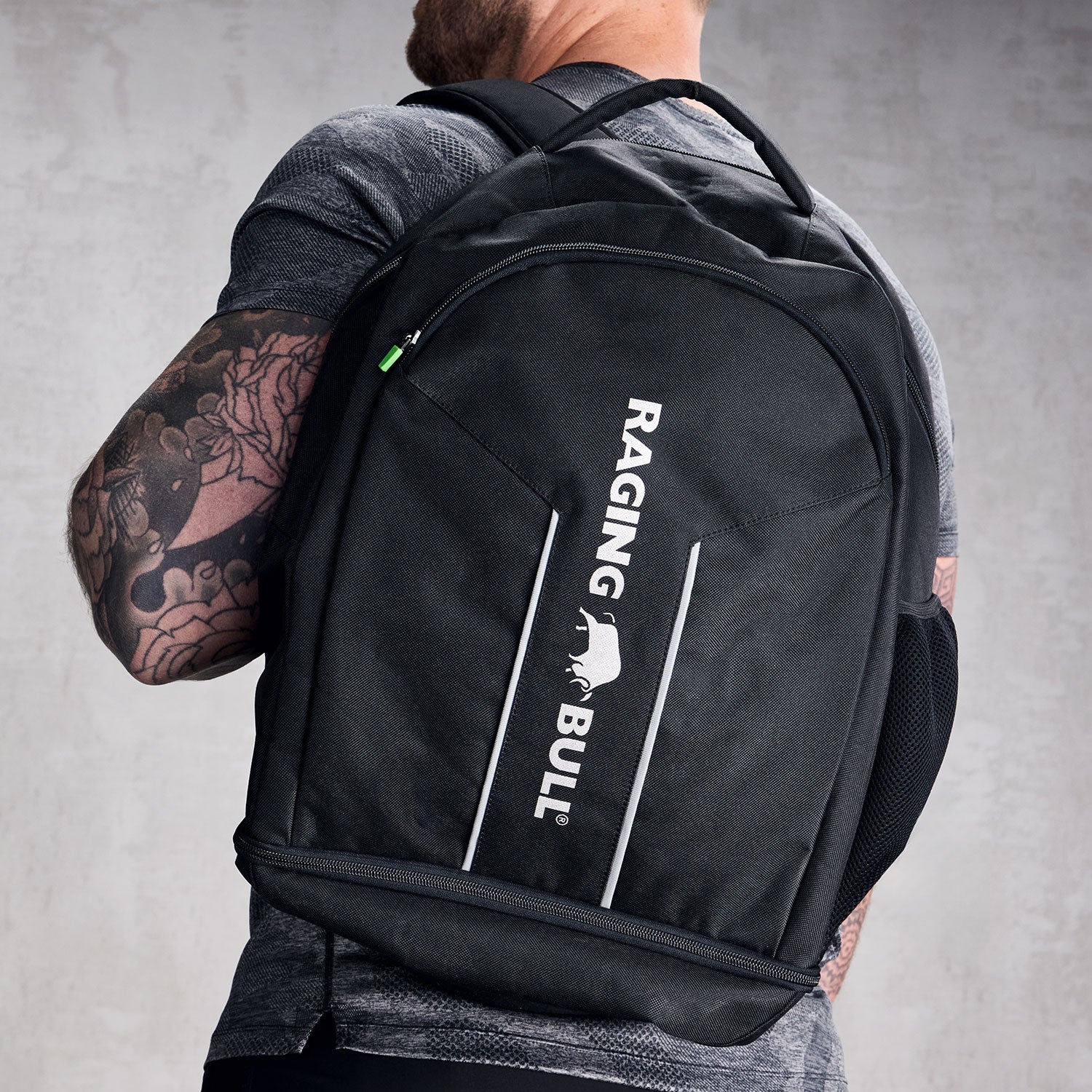 Close-up of a black rucksack with a Raging Bull logo. 