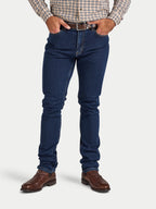 Person wearing blue jeans and a plaid shirt on a white background