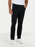 Person wearing black jeans and white sneakers on a white background