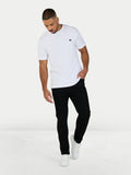 Man wearing a white t-shirt and black pants on a white background
