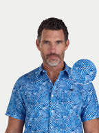Close-up of a man wearing Raging Bull Bali Palm Linen Short Sleeve Shirt in Sky Blue, available in sizes S-6XL, front detail. 