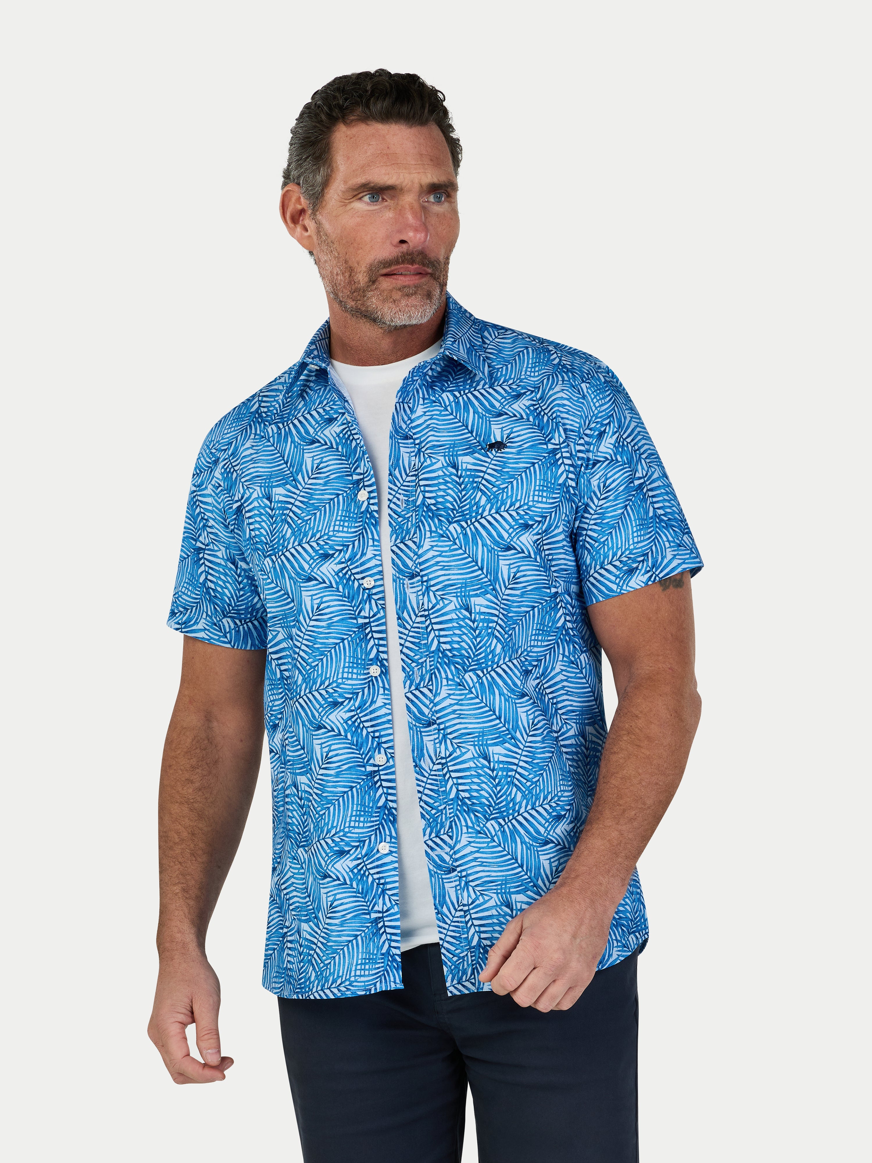 Man wearing a blue patterned shirt on a white background