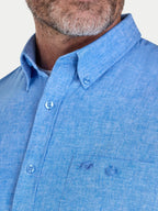 Man wearing Raging Bull Classic Linen Short Sleeve Shirt in Electric Blue, collar and chest detail, available in sizes S-6XL.