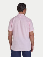 Man wearing a light pink short-sleeve shirt on a white background