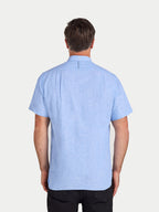 Man wearing a light blue short-sleeve shirt on a white background