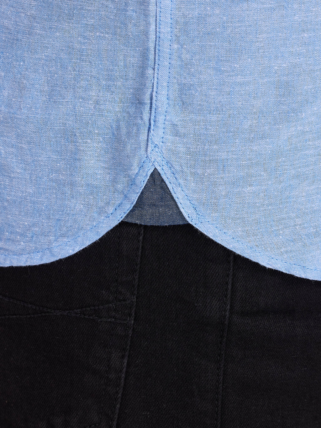 Close-up of a garment with a blue top and black bottom.