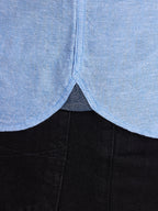 Close-up of a garment with a blue top and black bottom.