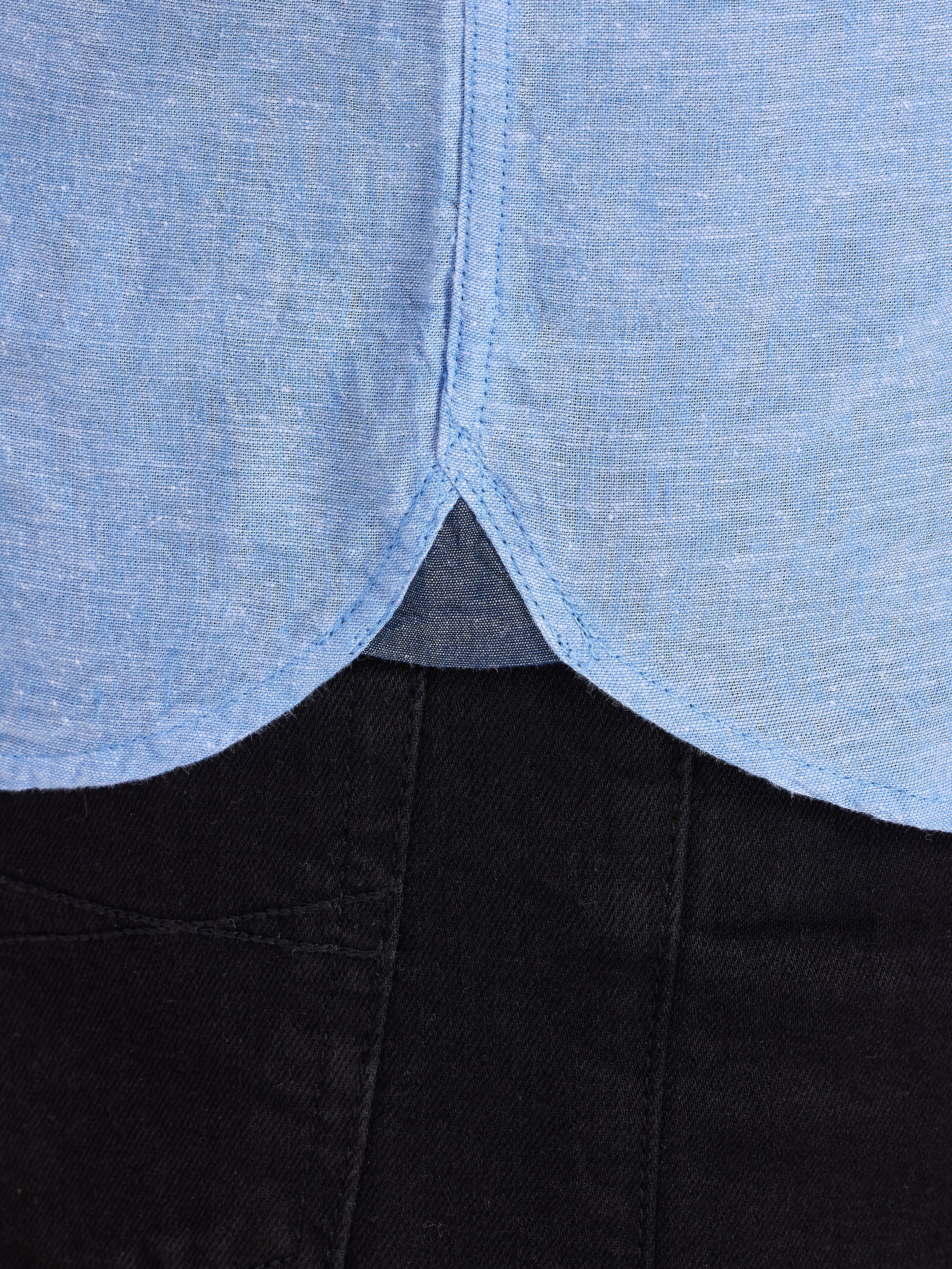 Close-up of a garment with a blue top and black bottom.