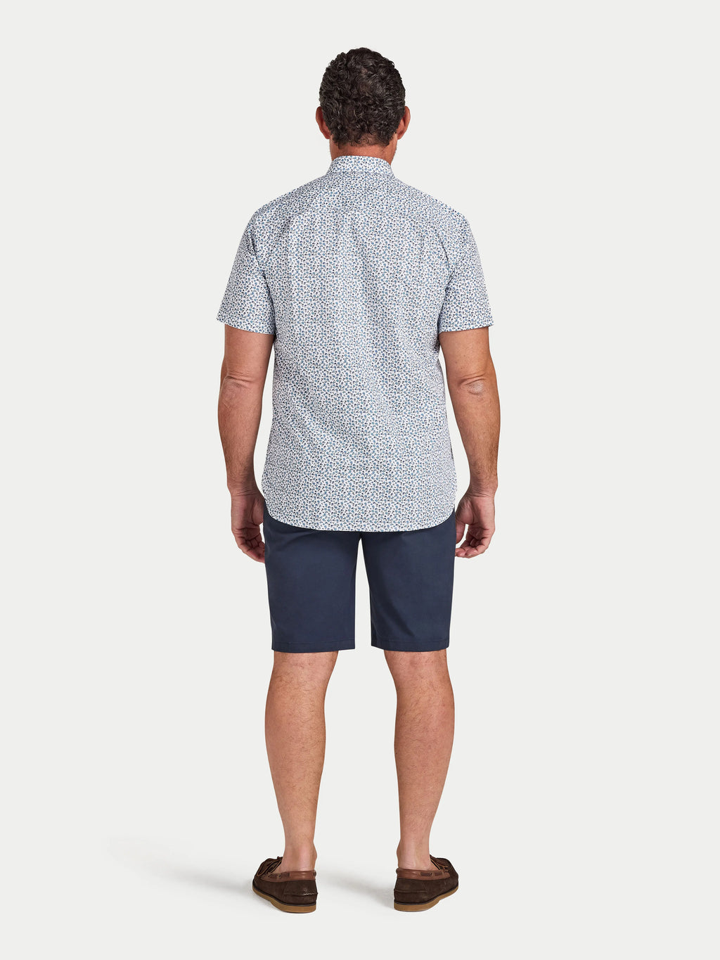 Man wearing Raging Bull Floral Cotton Poplin Short Sleeve Shirt in Sky Blue and Classic Chino Shorts in navy, back detail, available in sizes S-6XL.