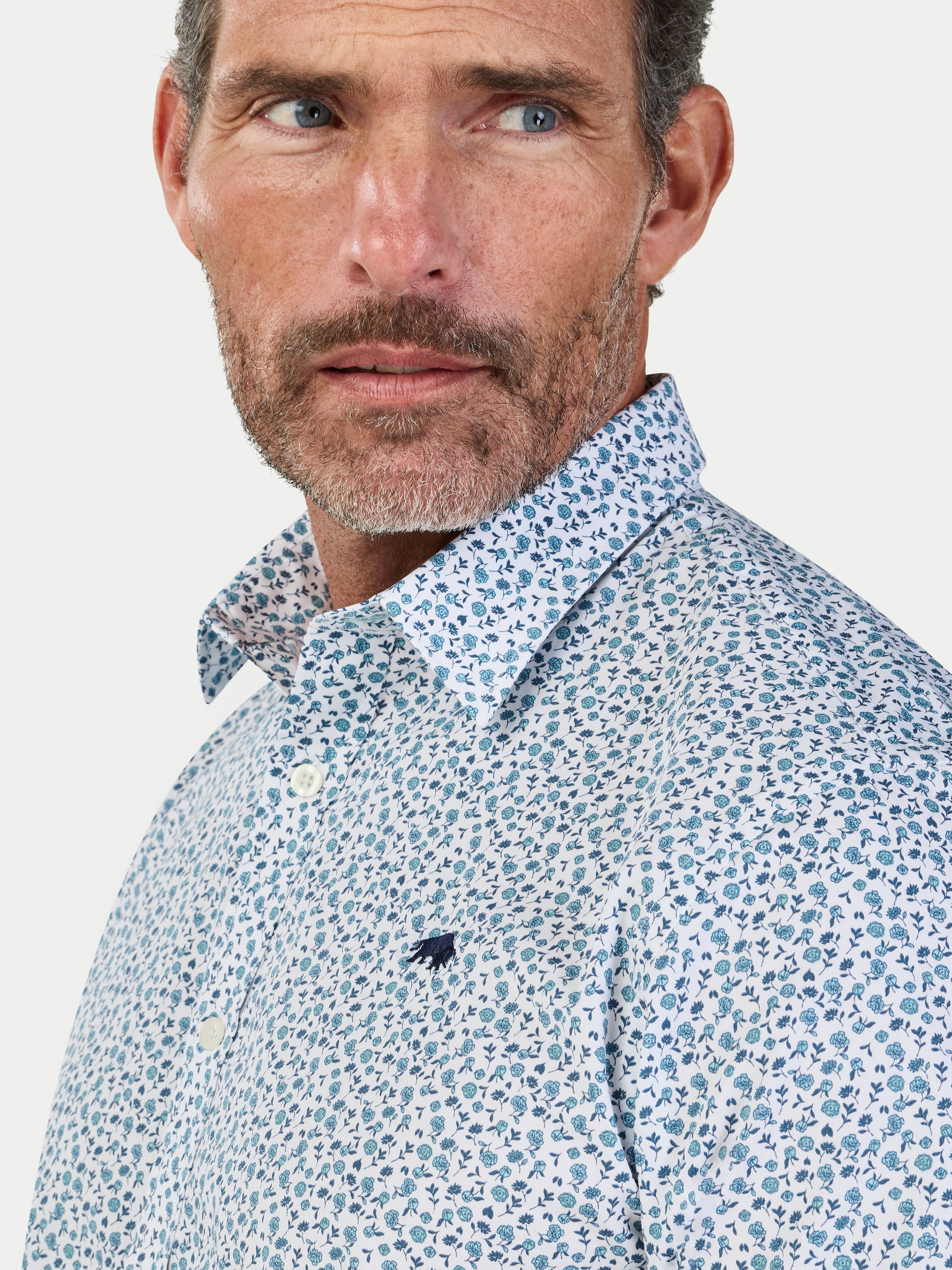 Man wearing Raging Bull Floral Cotton Poplin Short Sleeve Shirt in Sky Blue, available in sizes S-6XL.