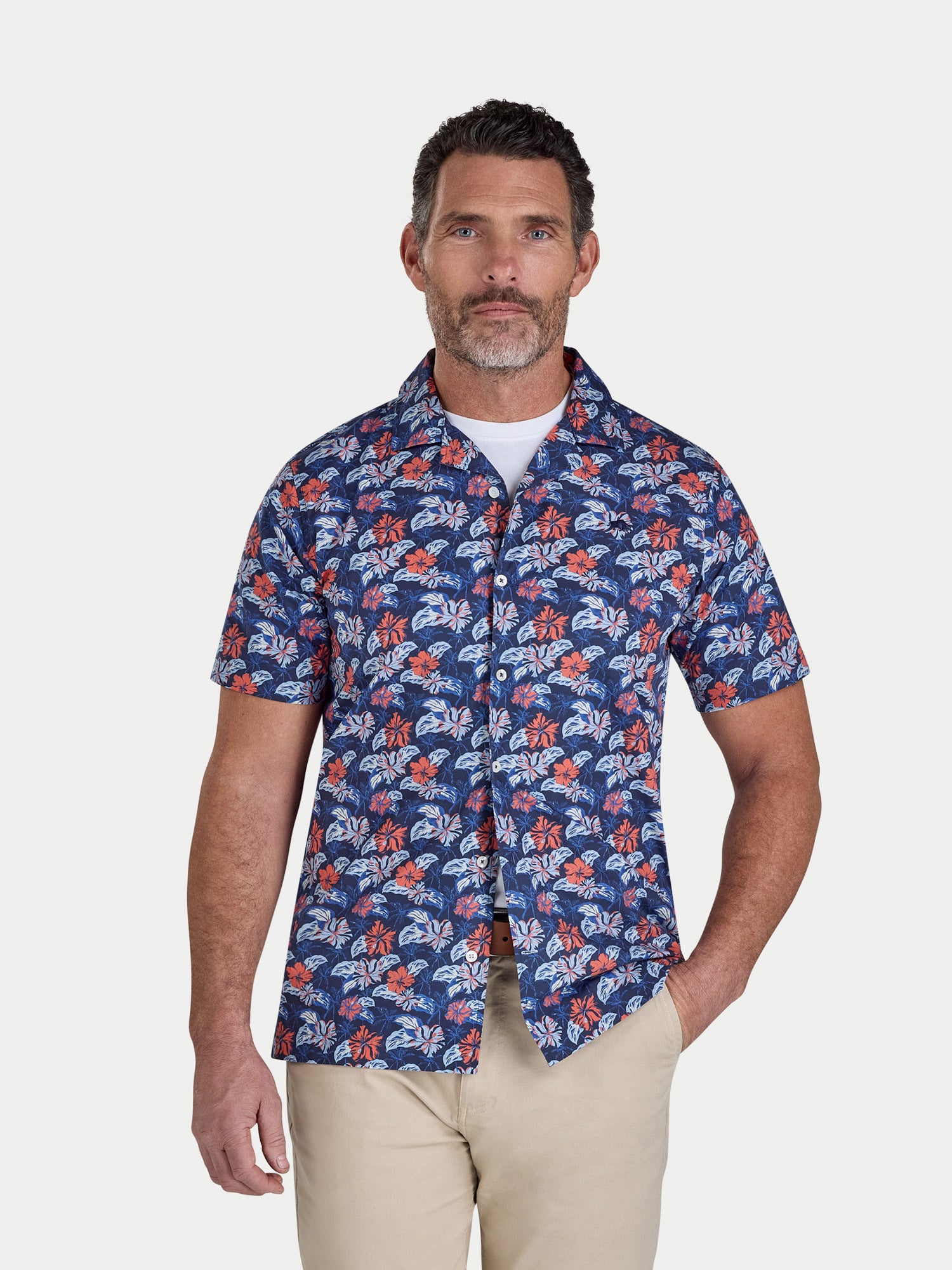 Man wearing a blue floral patterned shirt on a white background