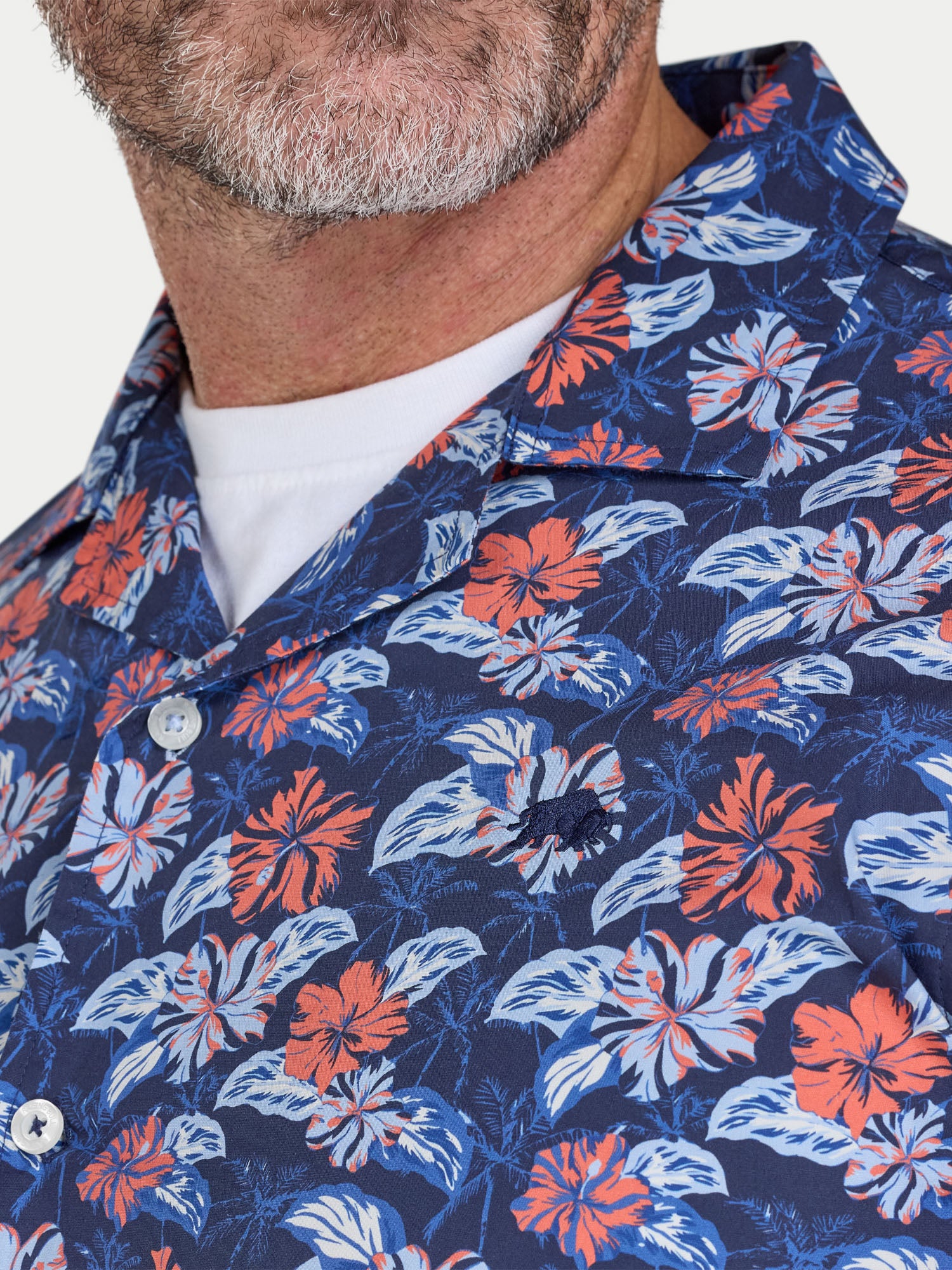 Man wearing Raging Bull Hawaii Floral Poplin Short Sleeve Shirt in Navy, chest and collar detail, available in sizes S-6XL.