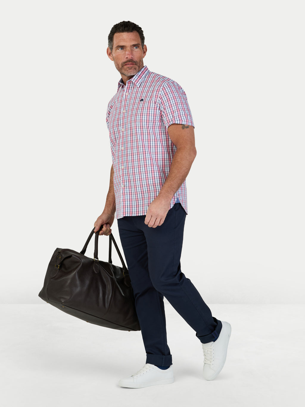 Man wearing Raging Bull Large Check Cotton Poplin Short Sleeve Shirt in Pink and Classic Chino Trousers in navy, available in sizes S-6XL