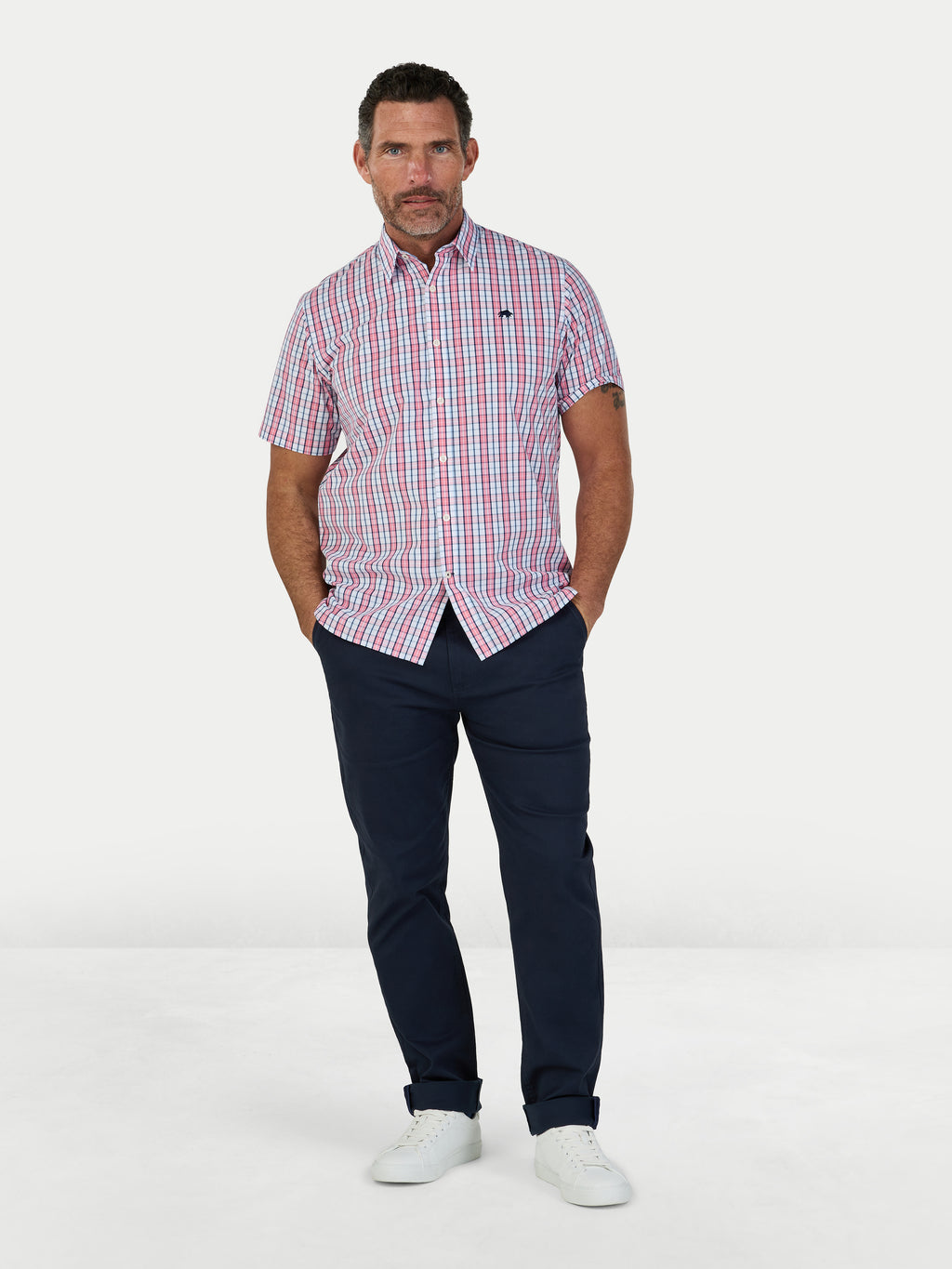 Man wearing Raging Bull Large Check Cotton Poplin Short Sleeve Shirt in Pink and Classic Chino Trousers in navy, available in sizes S-6XL