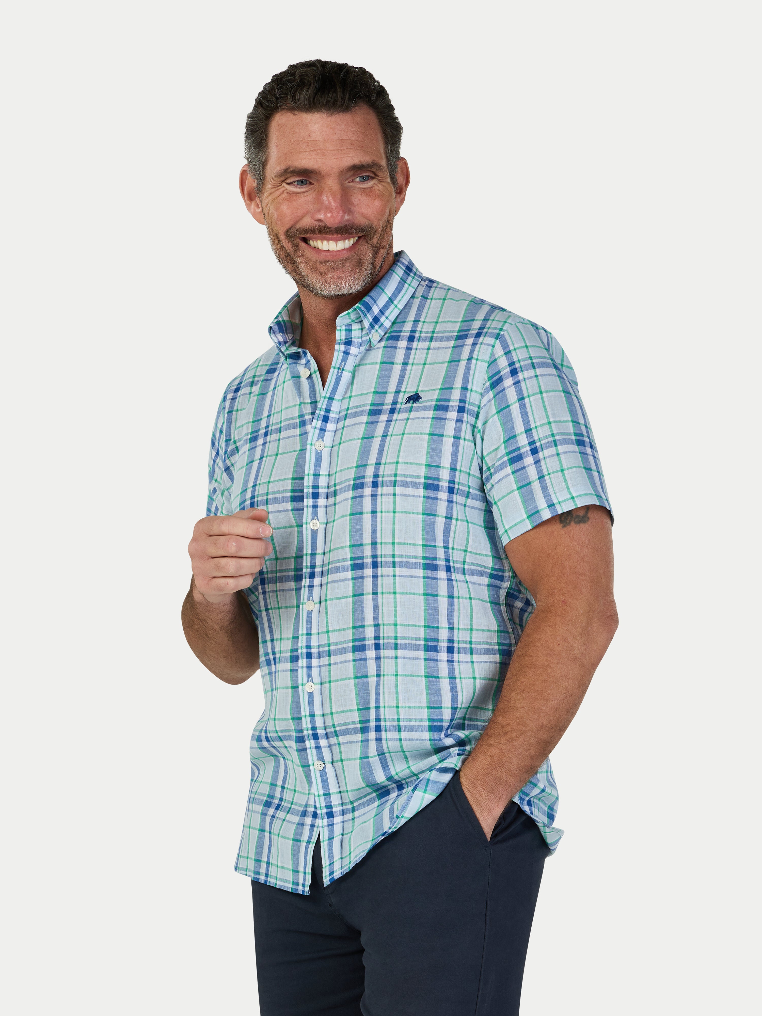 Man wearing a blue plaid shirt on a white background