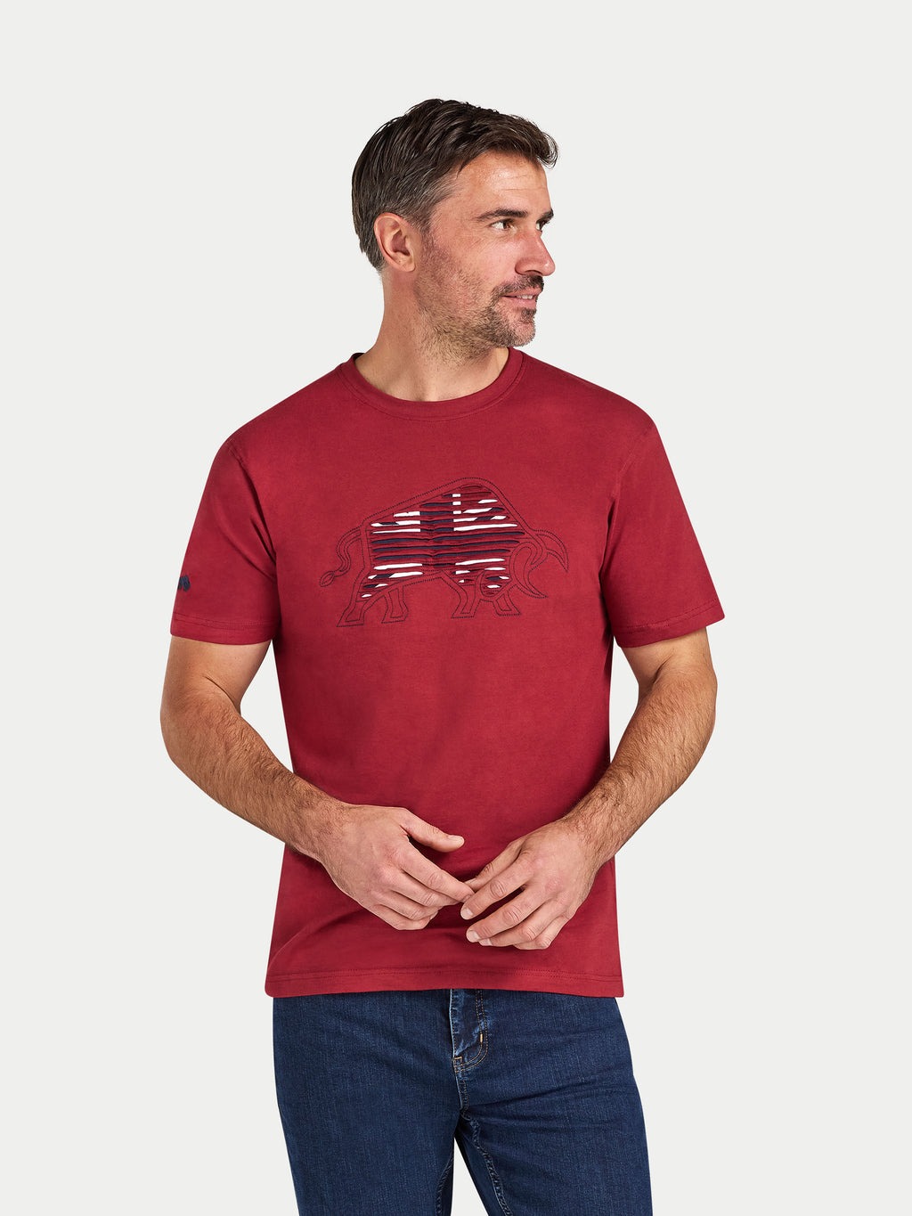 Man wearing a red t-shirt with a graphic design on a white background