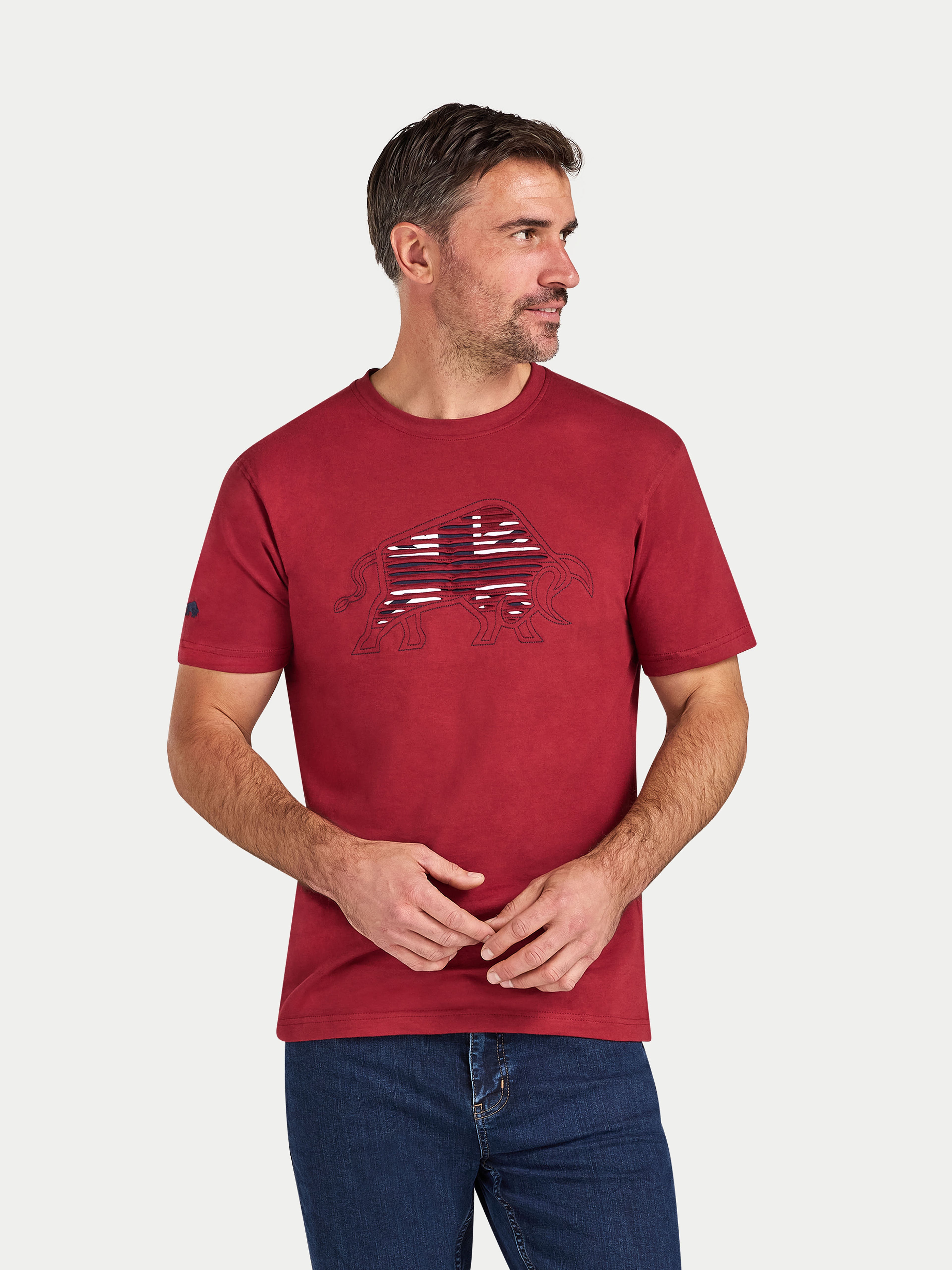 Man wearing a red t-shirt with a graphic design on a white background