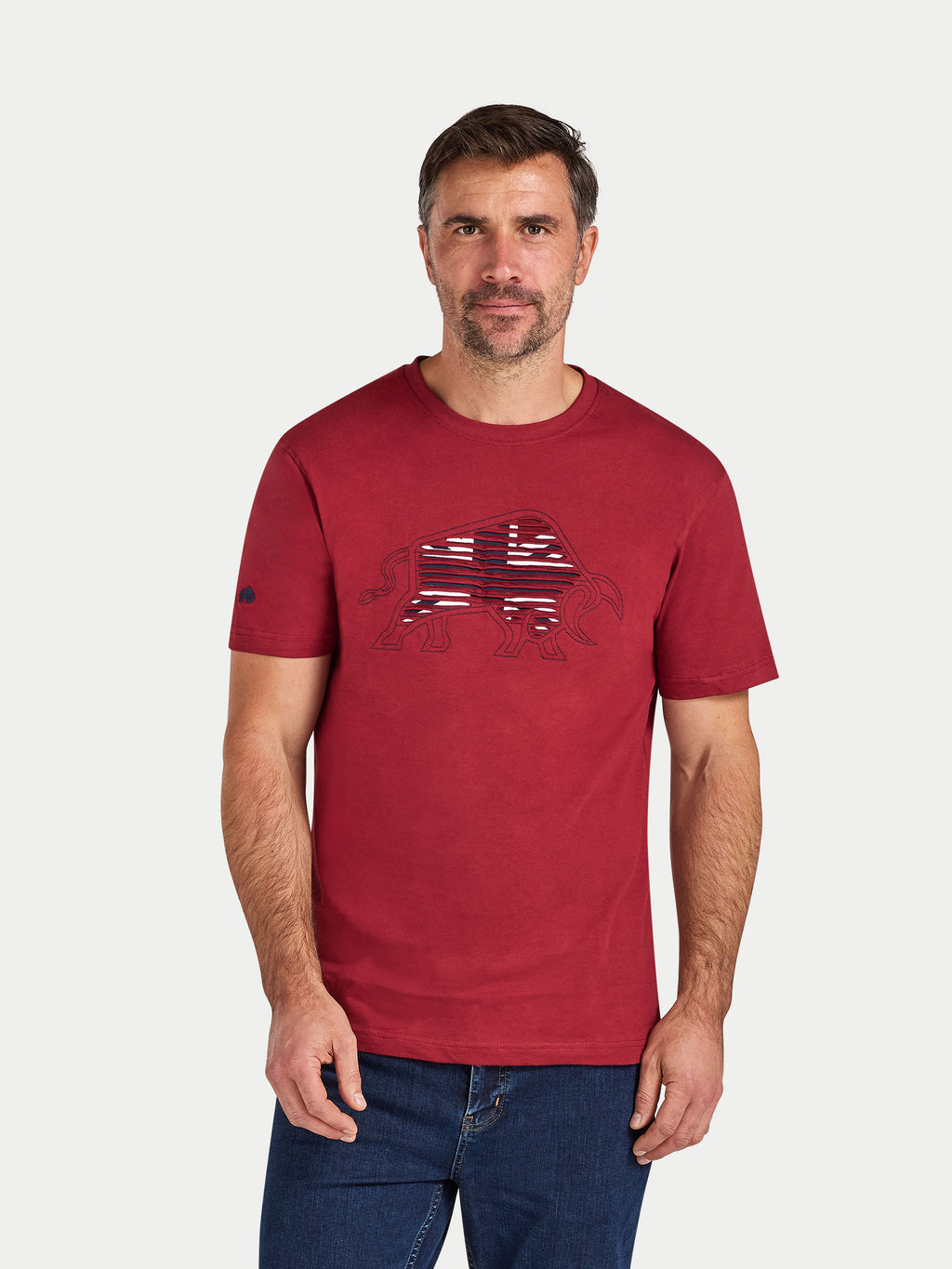 Man wearing a red t-shirt with a graphic design on a white background