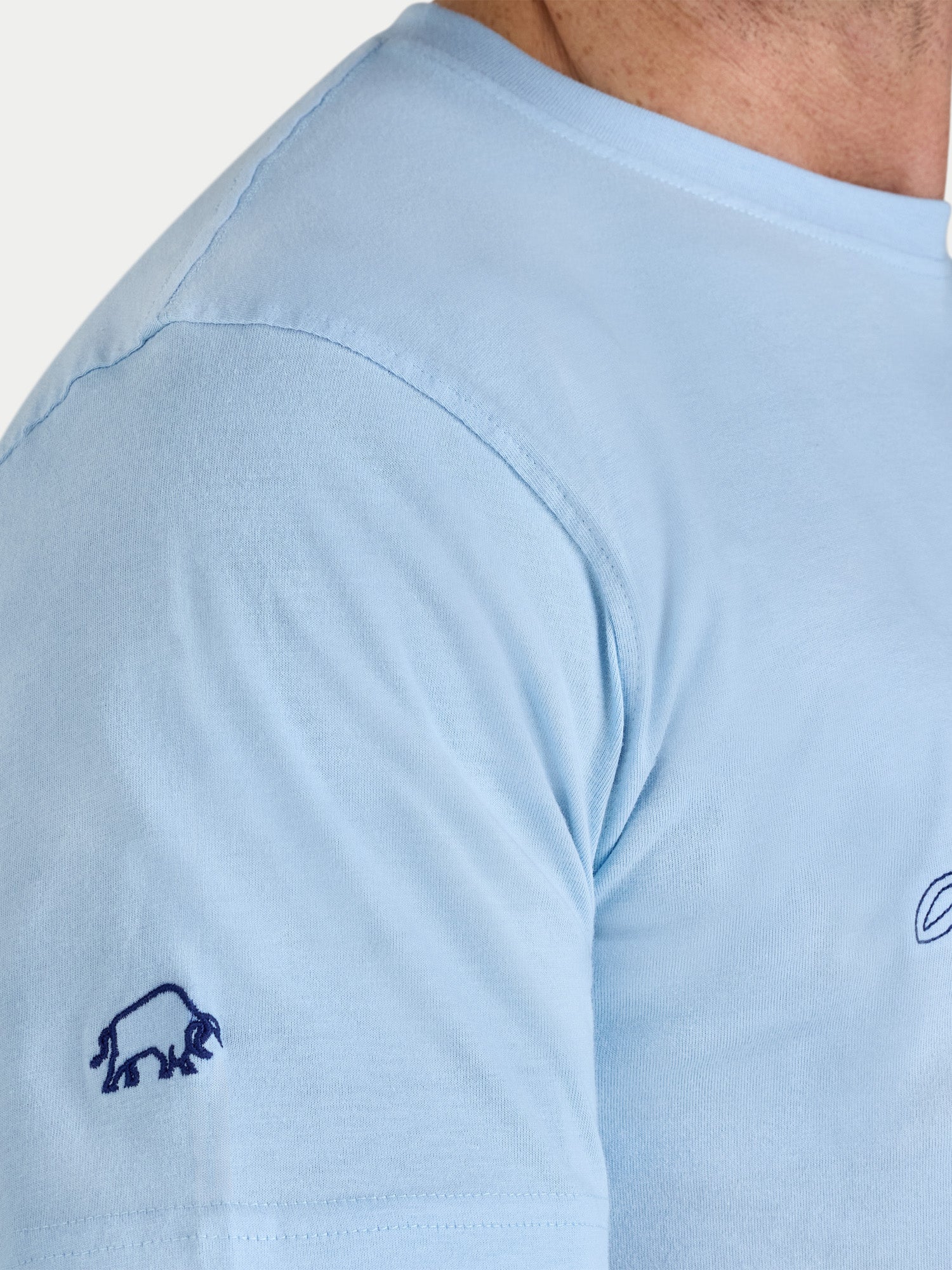 Light blue t-shirt with a small logo on the chest area