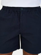 Black shorts with a button on a white background