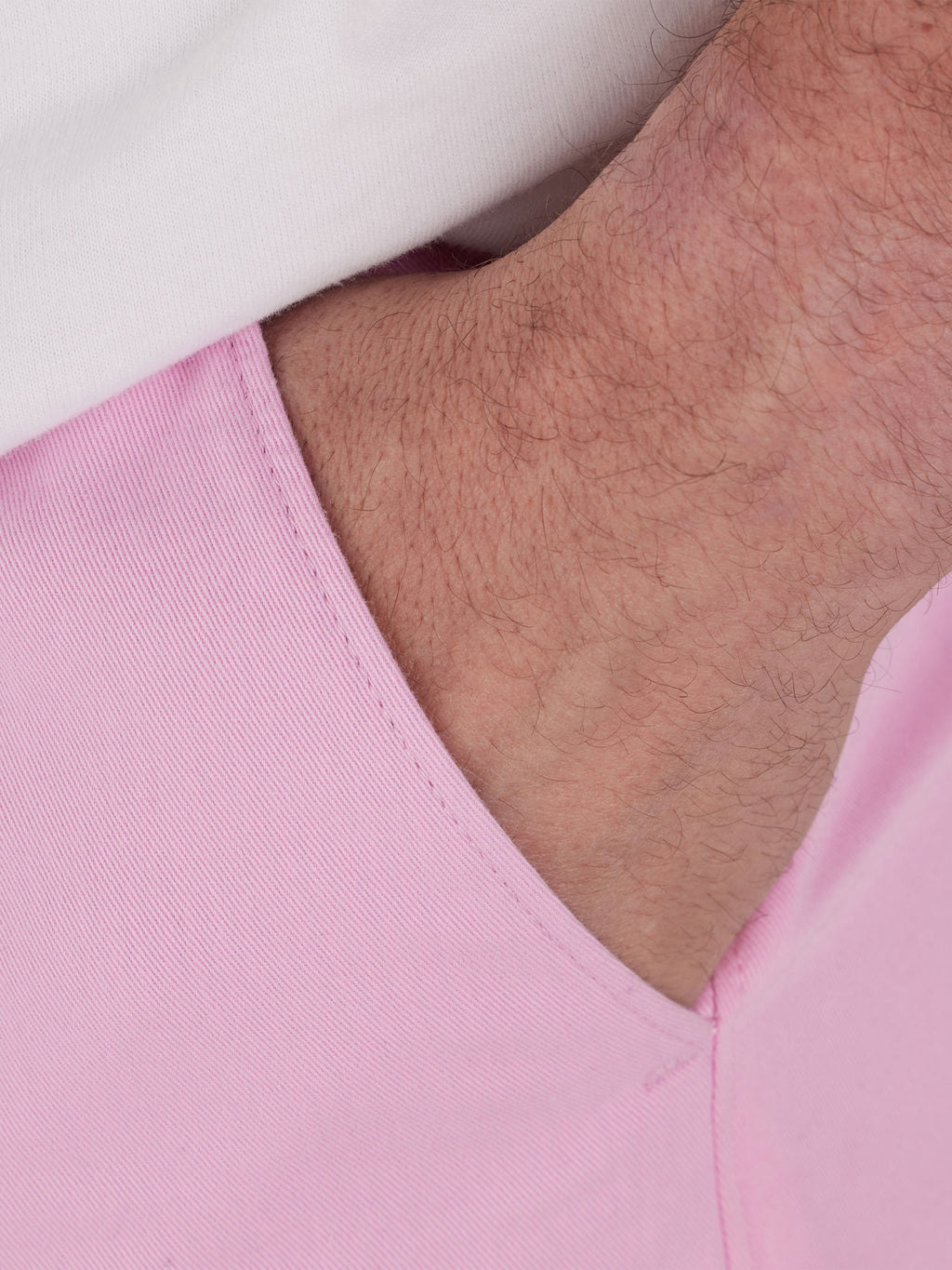 Close-up on a hand in the pocket of the shorts. 