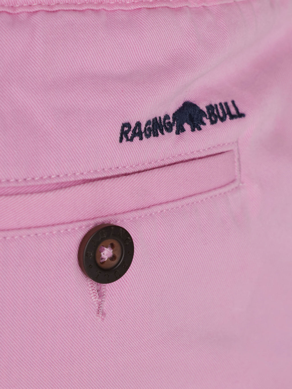 Close-up to the back pocket of the shorts with a Raging Bull logo on top of the pocket. 