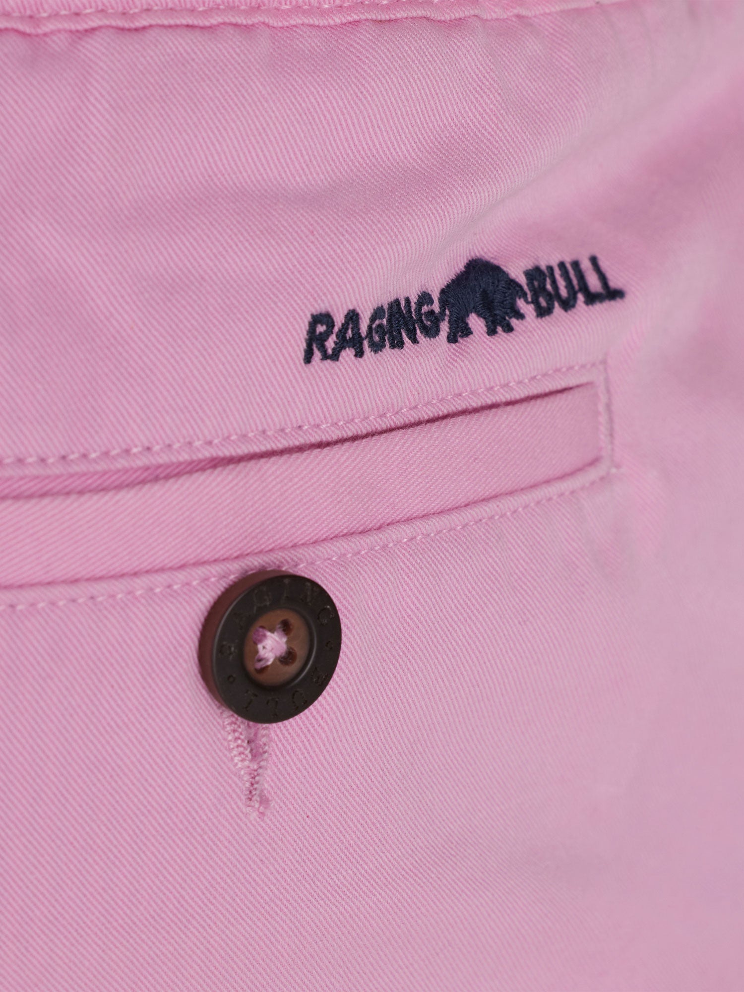 Close-up to the back pocket of the shorts with a Raging Bull logo on top of the pocket. 